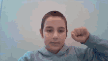 a young boy wearing a hoodie with the letter n on the front