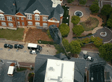 an aerial view of a city with a helicopter parked in front of a building