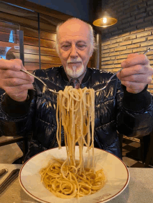 an older man is eating spaghetti with a fork and knife
