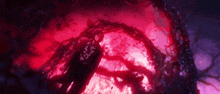 a person is standing in a dark room with a red light coming out of the ground .