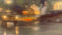 a blurry picture of a city street with a sign that says ' abercrombie & fitch '
