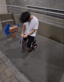 a man is laying on the ground in front of a rocking horse in a playground