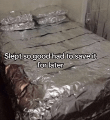 a bed that is covered in aluminum foil with the words slept so good had to save it for later