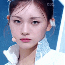 a close up of a woman 's face with kbs on the bottom right