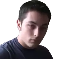 a close up of a man 's face with a blue shirt on