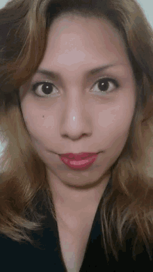 a woman with blonde hair is wearing red lipstick