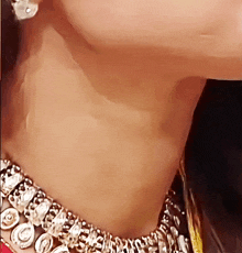 a close up of a woman 's neck wearing a necklace