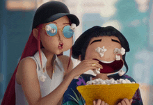 two cartoon characters are eating popcorn with their eyes covered in popcorn