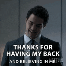 a man in a suit and tie is smiling and saying thanks for having my back and believing in me !