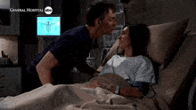 a man kisses a woman in a hospital bed which says general hospital