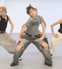 a group of people are dancing and one of them is wearing a t-shirt that says jaysol