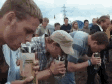 a group of men are drinking out of a cup that says ' coca cola ' on it