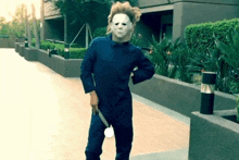 a man in a mask is holding a knife in his hand