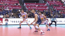 a volleyball game is being played in front of a large crowd