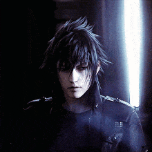 a man with long black hair is standing in a dark room with a light behind him