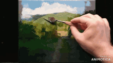 a person is painting a landscape with the words made in animotica below them
