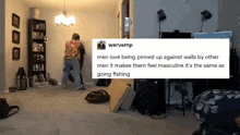 a man is pinned up against a wall by another man .