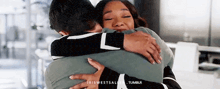 a man and woman are hugging each other in a room .
