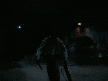 a man is holding a briefcase and a knife in a dark scene