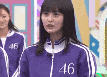 a girl wearing a purple jacket with the number 46 on the front