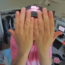 a young man wearing a pink shirt and a hat that says only world rides