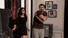 a man and a woman are hugging in front of a fridge that says ' lg ' on it