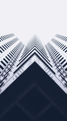 looking up at a black and white building with a diagonal pattern