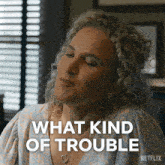 a woman with curly hair says what kind of trouble on a netflix ad