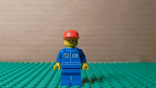 a lego man wearing a blue shirt that says oil