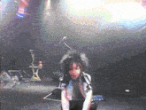 a man with black hair and a shirt that says ' r ' on it