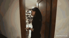 a woman opens a door with the words made in animatica below her