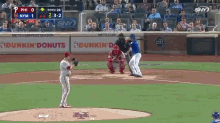 a dunkin donuts ad is on the wall of a baseball field