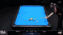 a man is playing pool on a table that says diamond