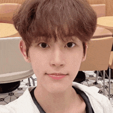 a young man with a piercing in his ear takes a picture of himself