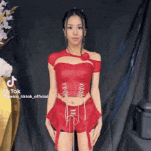a tiktok video of a woman in a red top