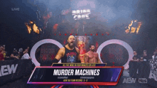 two wrestlers are standing in a ring with a banner that says " murder machines "