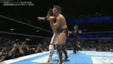 a man in a wrestling ring with the word kushida on the screen