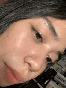 a close up of a woman 's face with a white board behind her that says ' i 'm sorry '