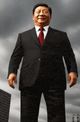 a man in a black suit and red tie stands in front of a cloudy sky