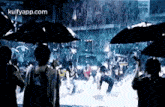 a group of people are holding umbrellas in the rain .