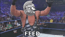 a man in a wrestling ring with the word feed written on it