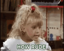 a little girl is sitting at a table with the words `` how rude '' on her face .