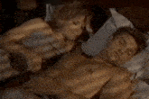 a man and a woman are laying on a bed with the word loriho on the bottom right