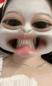 a woman with a white mask on her face and a necklace