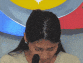 a woman sitting in front of a microphone with a star on her head