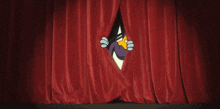 a cartoon character in a tuxedo is standing in front of a red curtain .