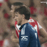 a soccer player wearing a blue shirt with the word technology on it