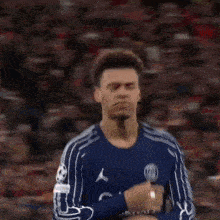 a blurred image of a man wearing a blue qatar airway jersey