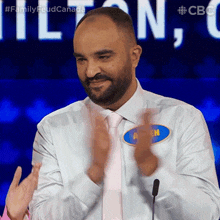 a man wearing a name tag that says allen is clapping his hands
