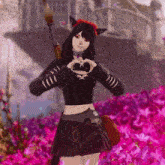 a girl making a heart shape with her hands in front of a pink flower field